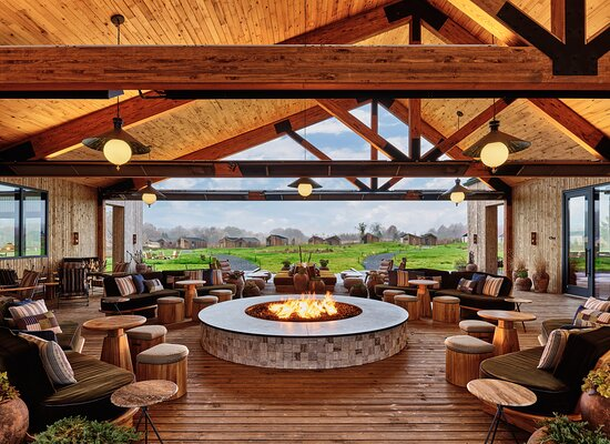 The firepit terrace at Wildflower Farms, with lounge seating and views to the ridge