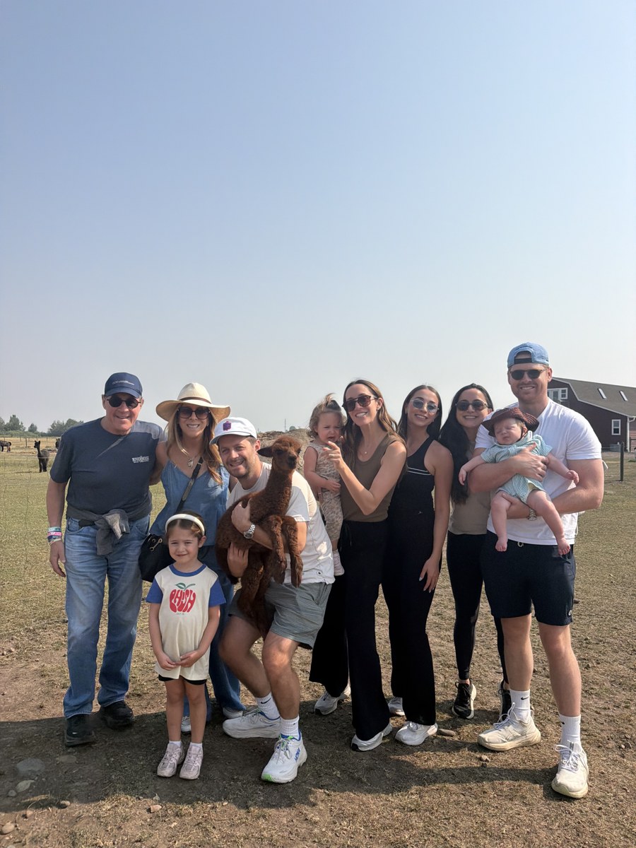 Three generations of Gina's family with an alpaca at Alpacas of Montana